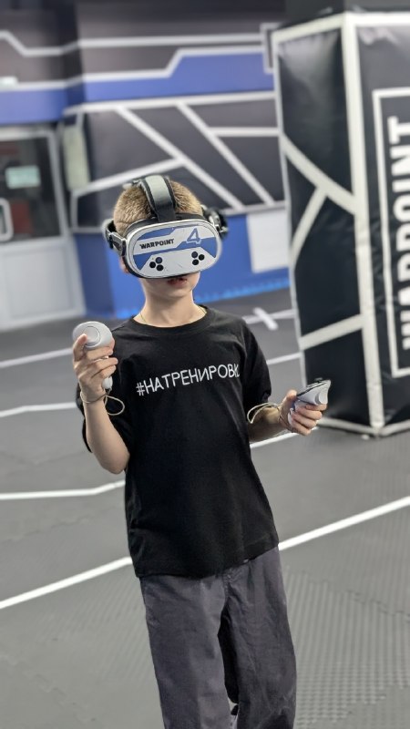 Команда в VR-зале: шлем по центру кадра, все в движении